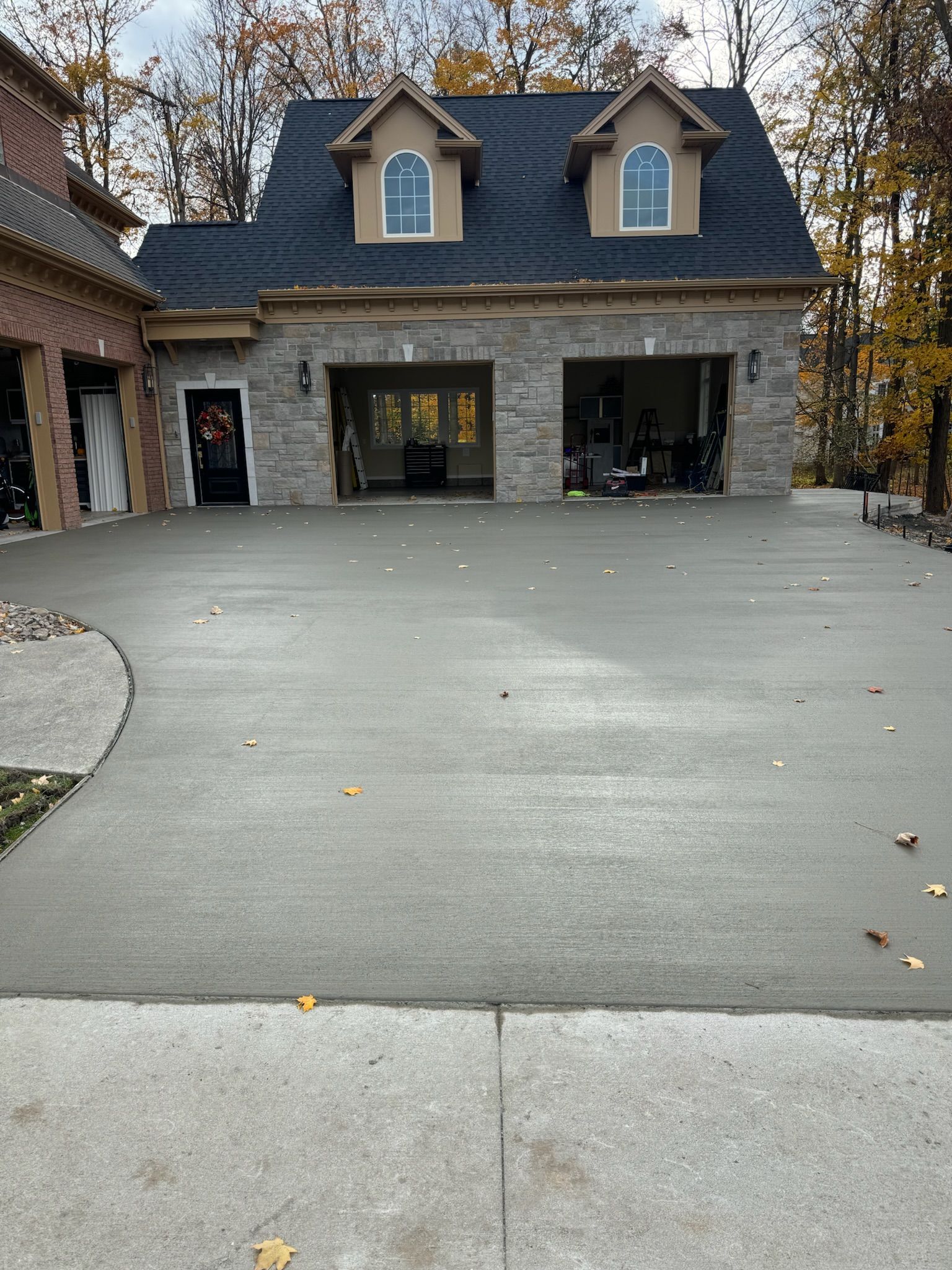 A large house with a concrete driveway in front of it.