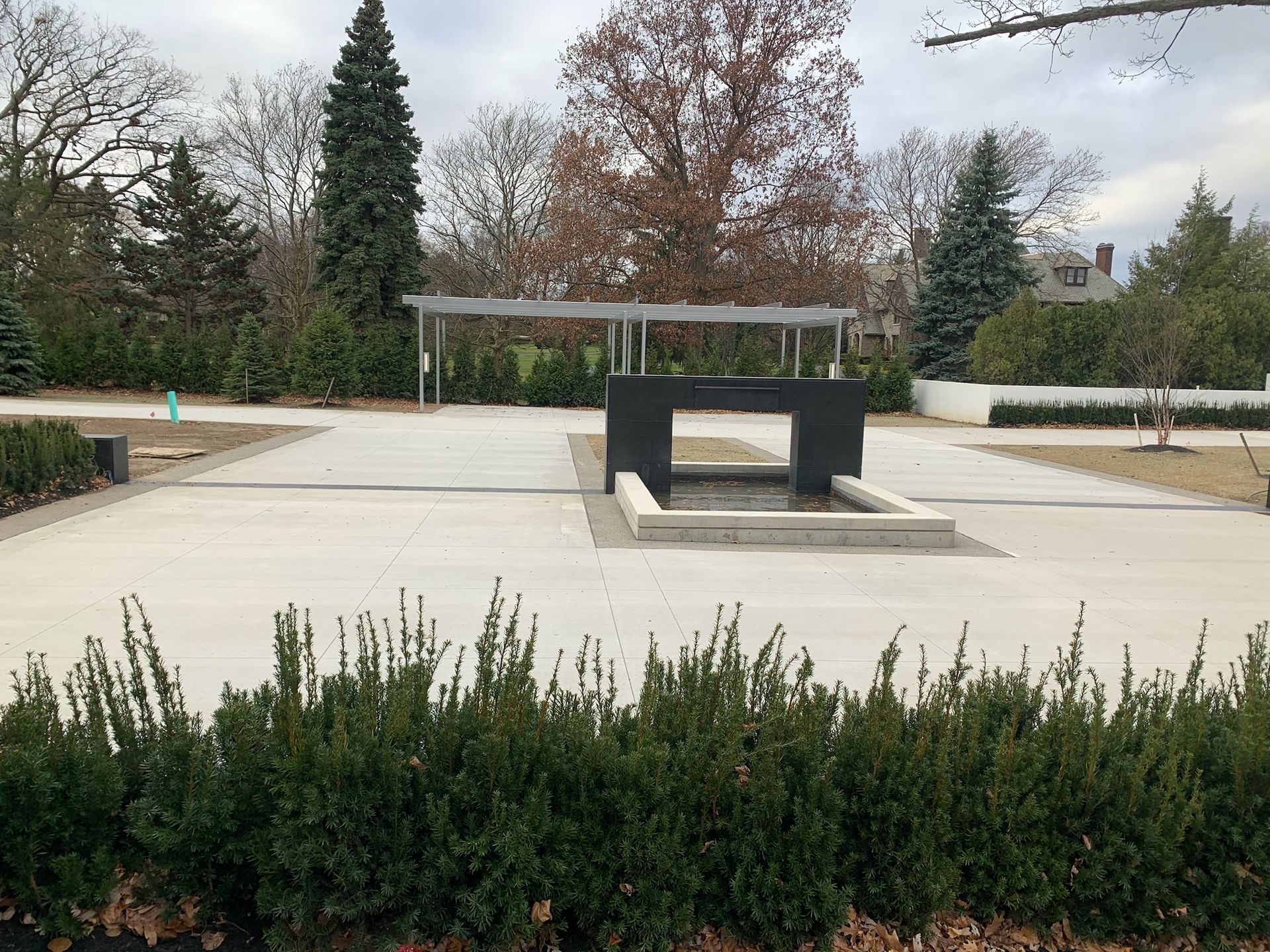 A concrete driveway with trees in the background
