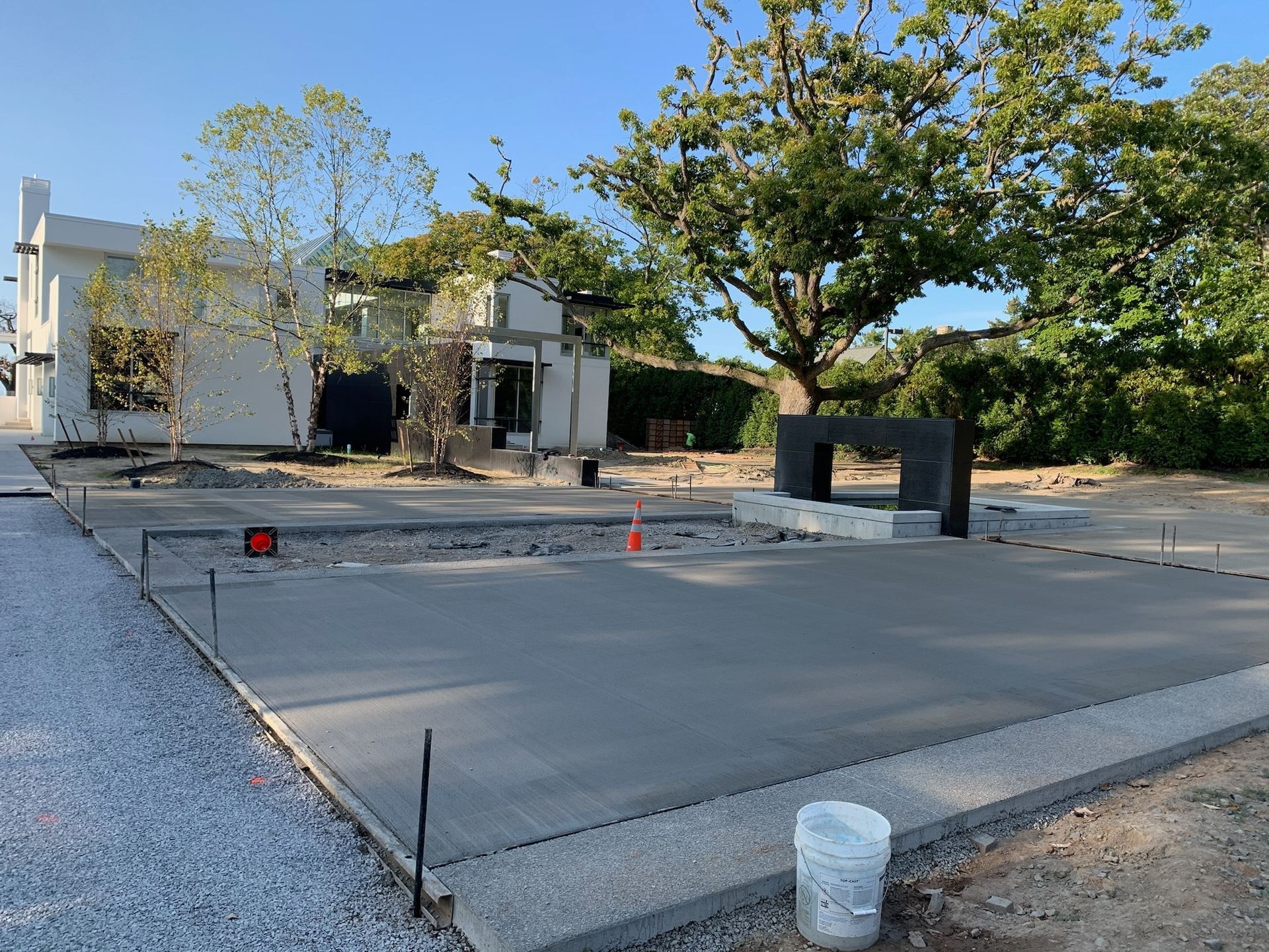 A concrete driveway is being built in front of a house