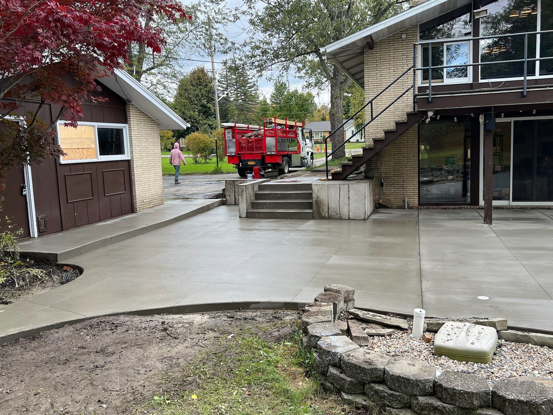 A red truck is parked in front of a house.