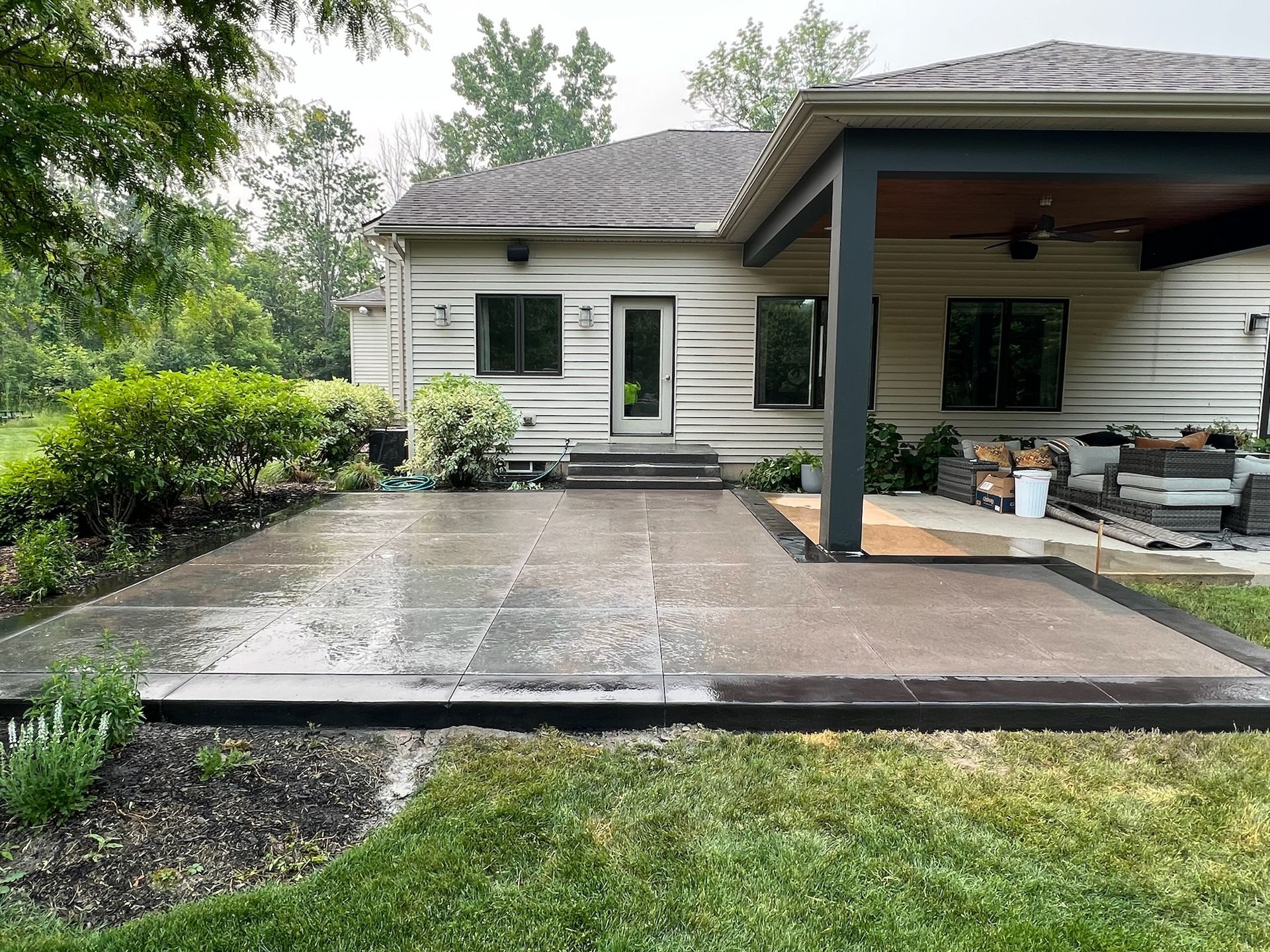 A house with a covered patio in front of it.
