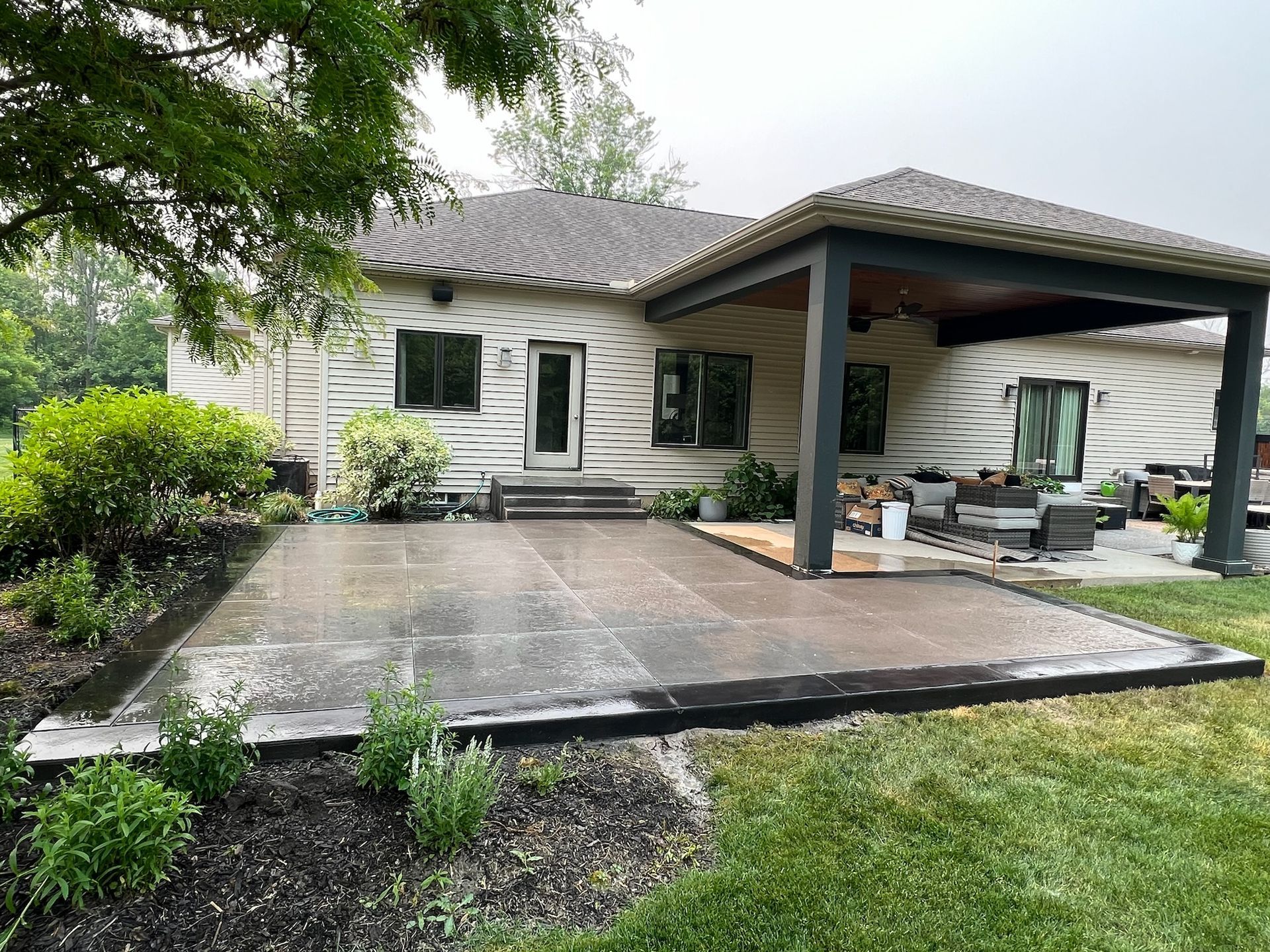 A house with a large patio in front of it.