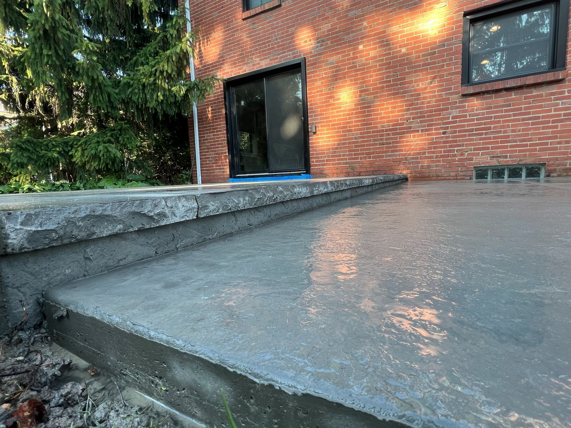 A concrete deck is being built in front of a brick building.