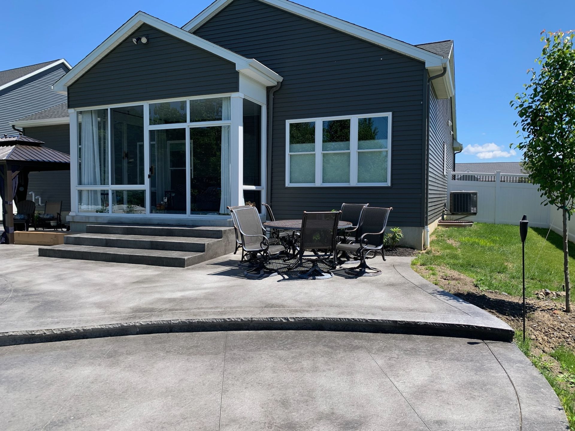 A house with a patio and a table and chairs in front of it