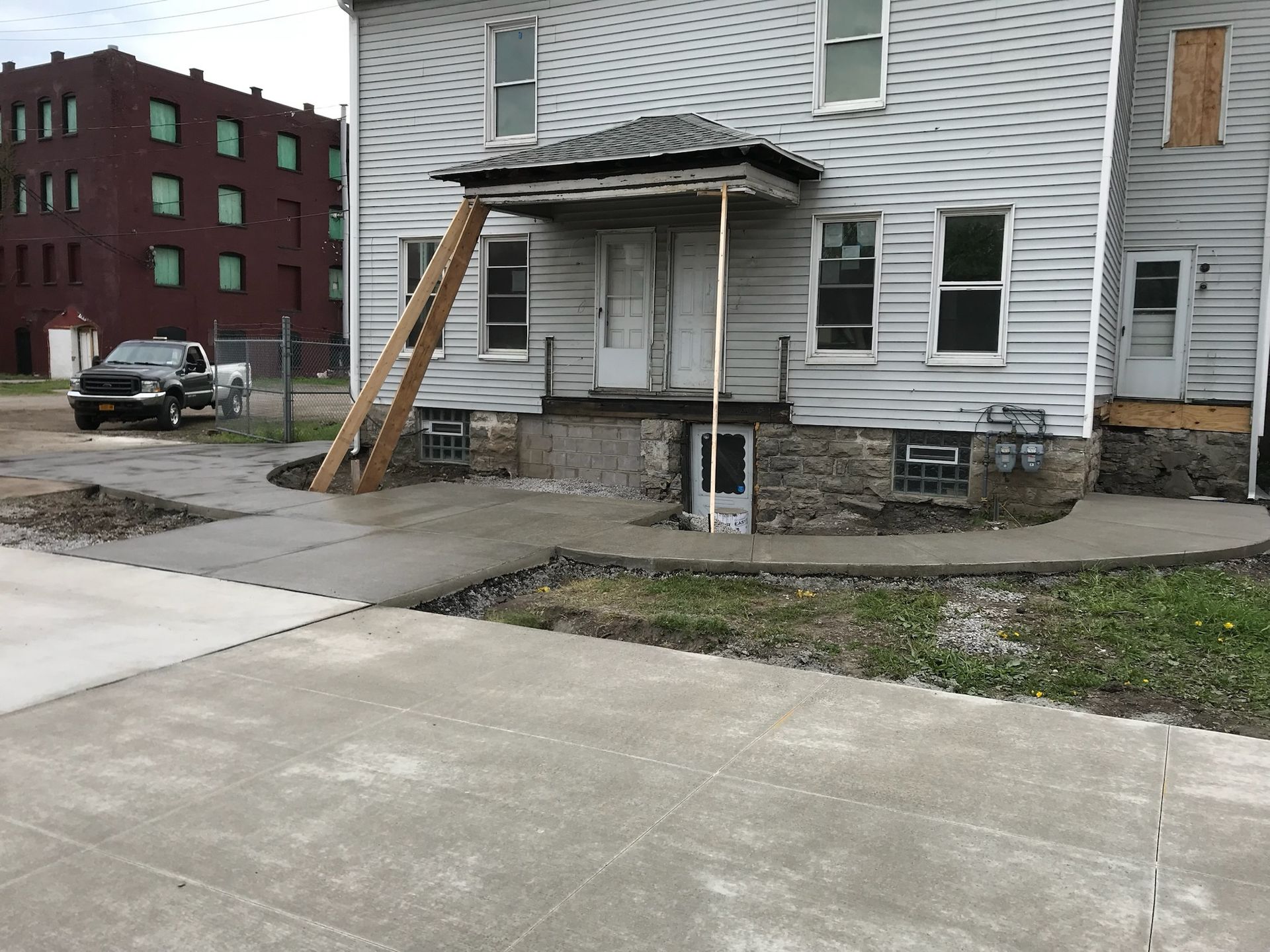 A white house with a concrete walkway in front of it