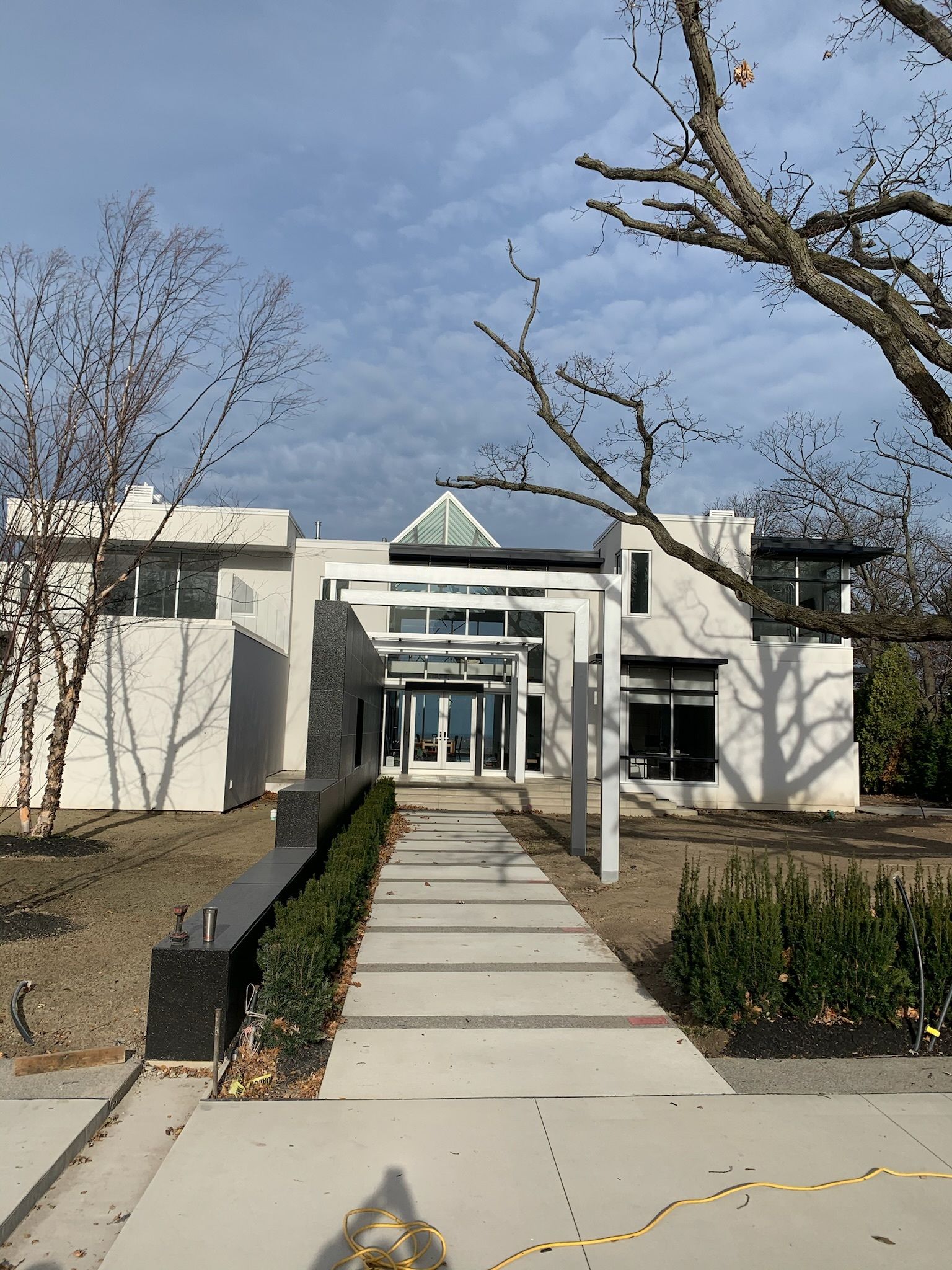 A large white building with a walkway leading to it.