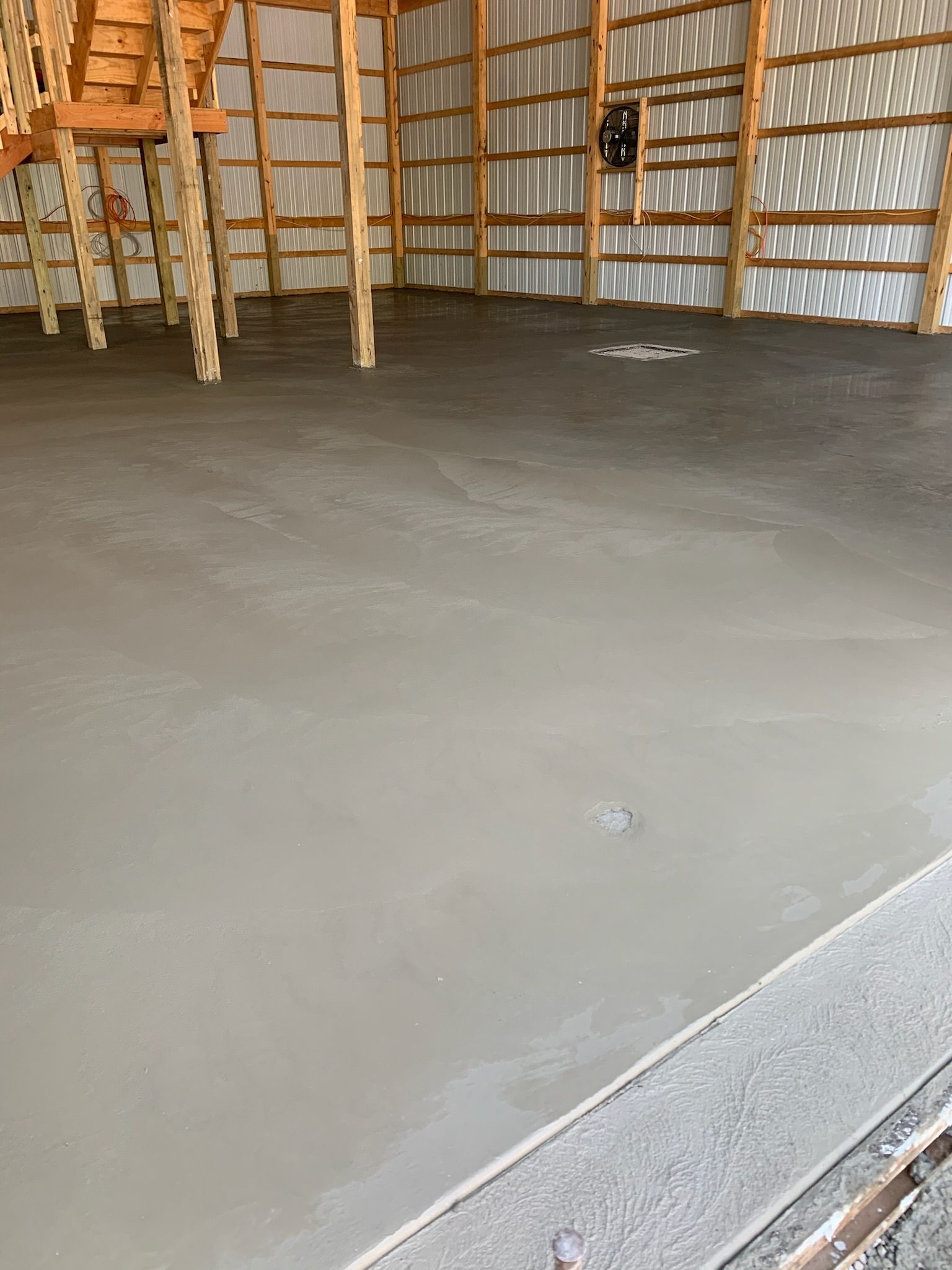 There is a concrete floor in the middle of a building.