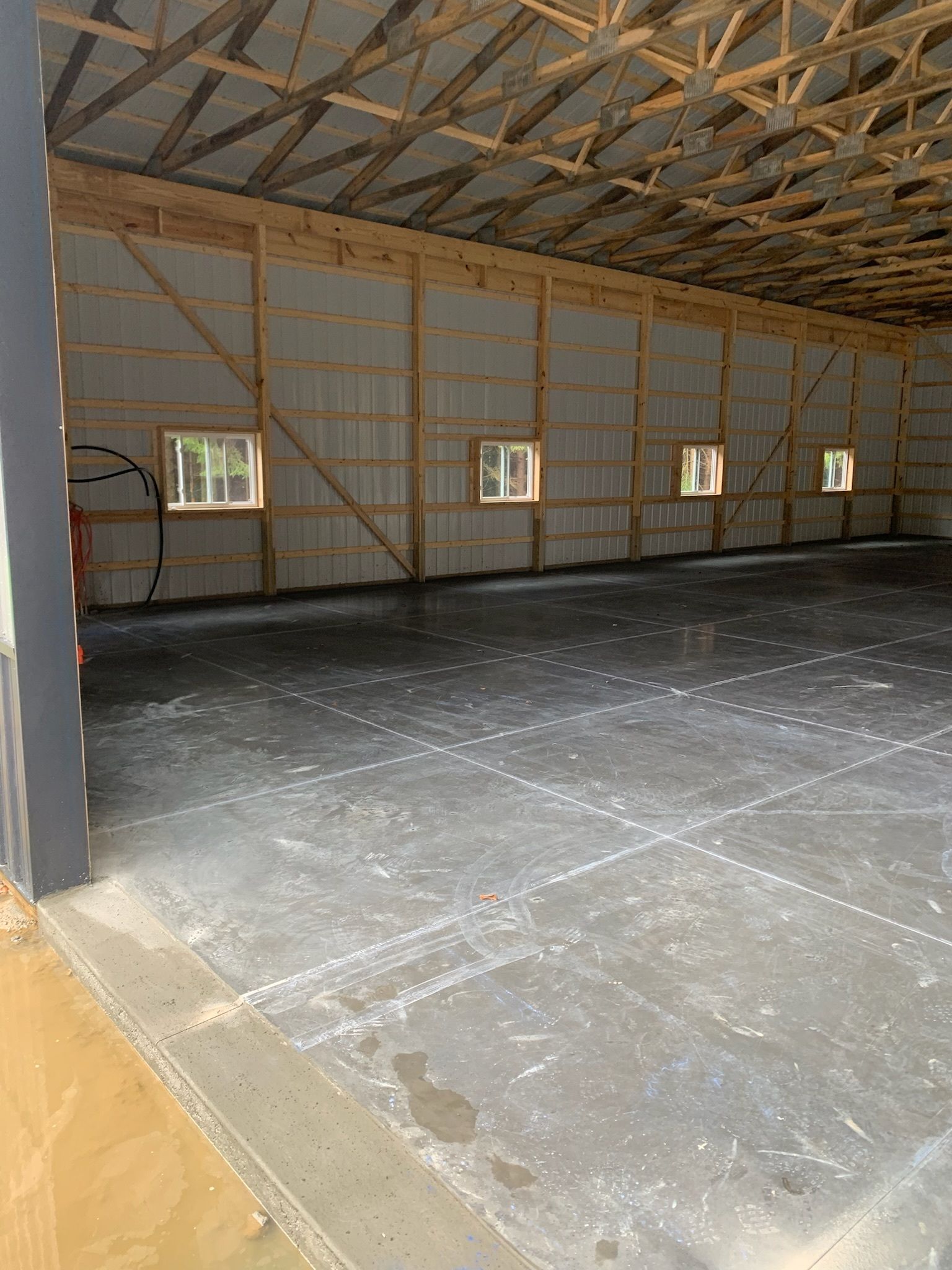 A large empty building with a basketball hoop inside of it.