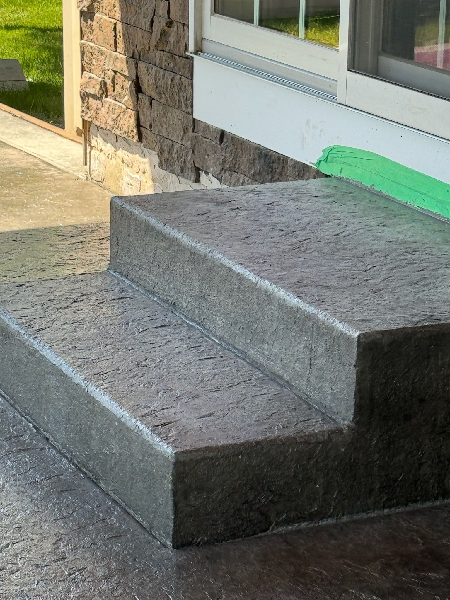 A set of concrete steps leading up to a house.
