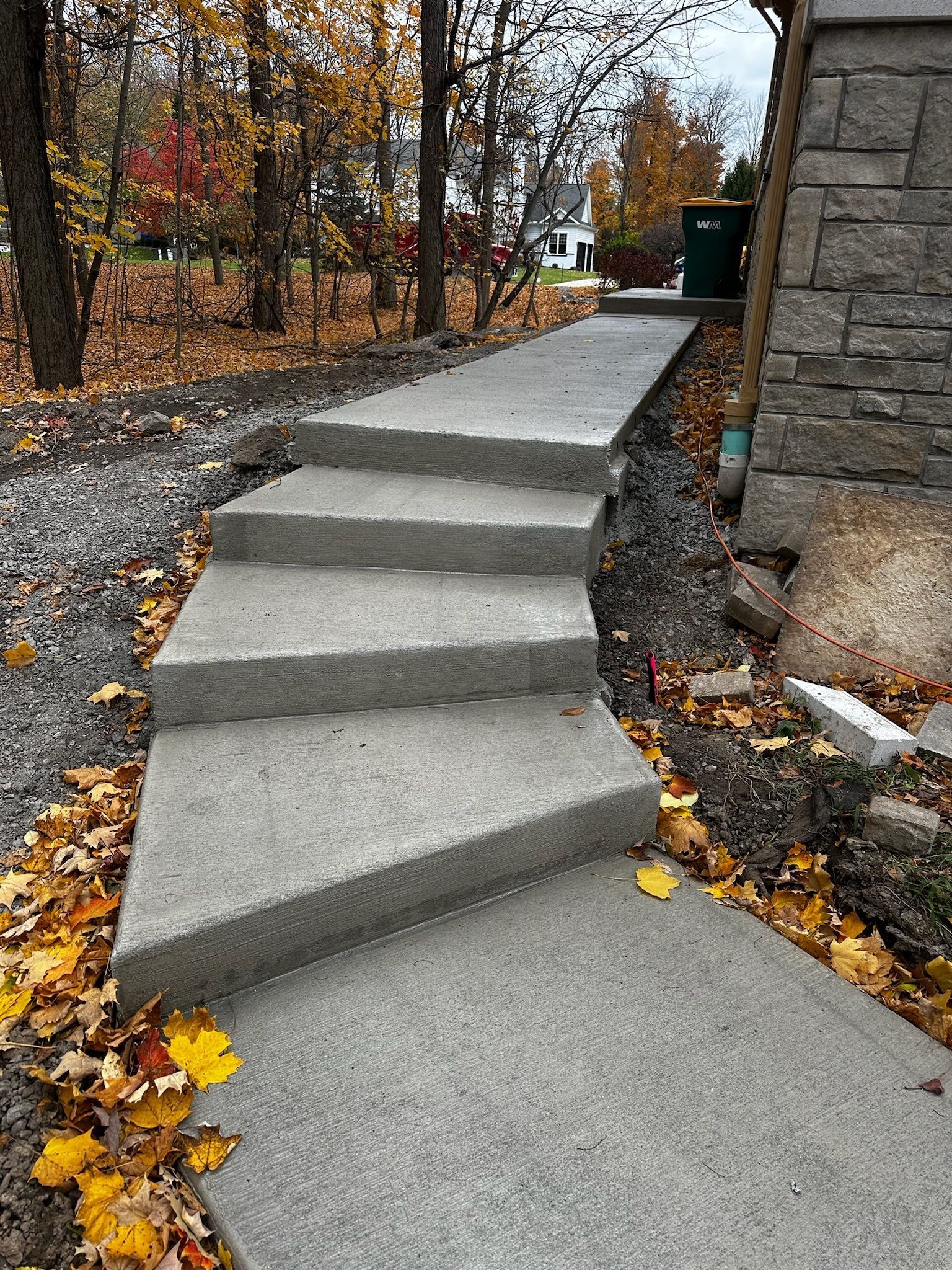 A set of concrete stairs leading up to a house.