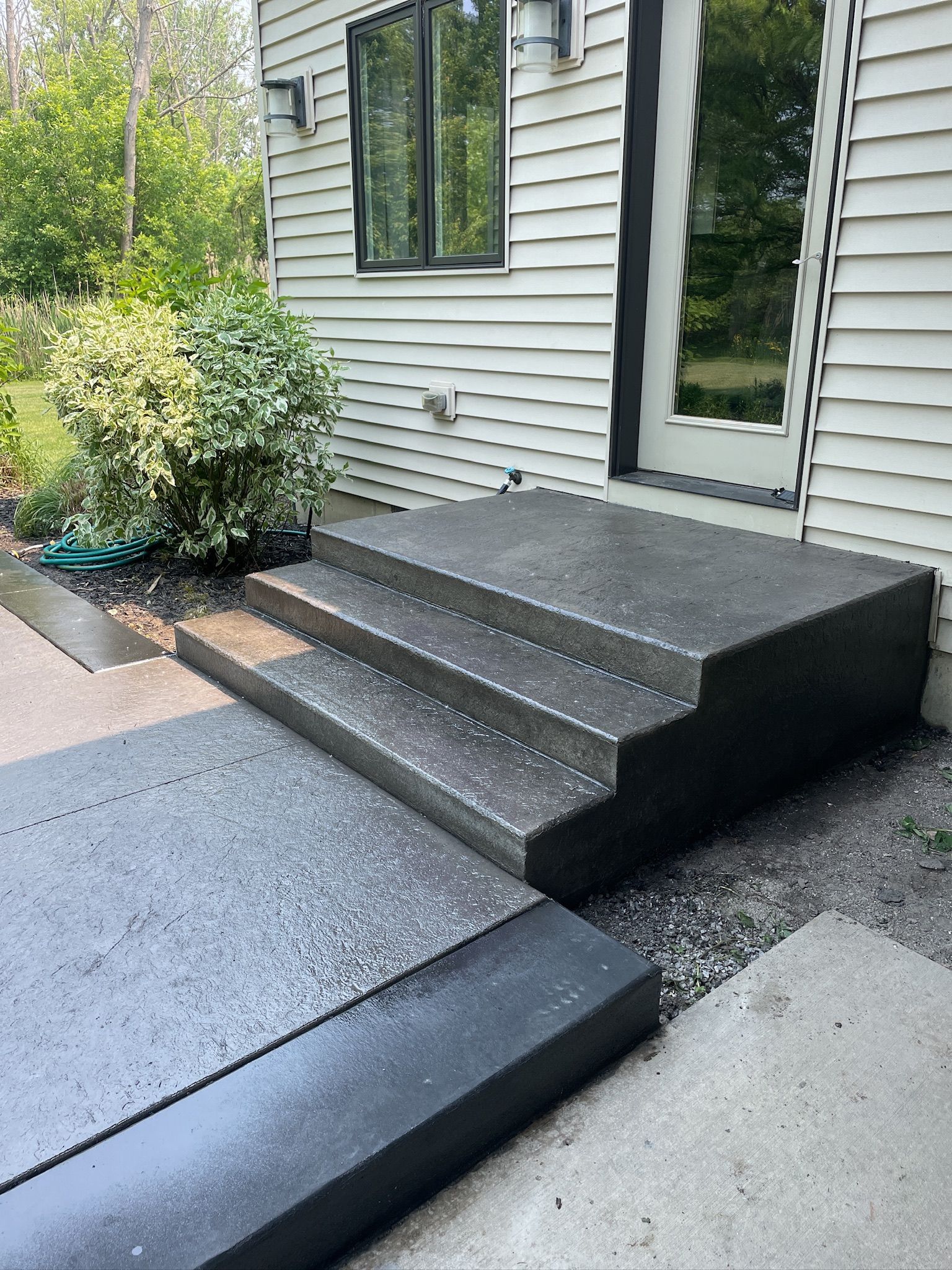 A set of concrete steps leading up to a house.