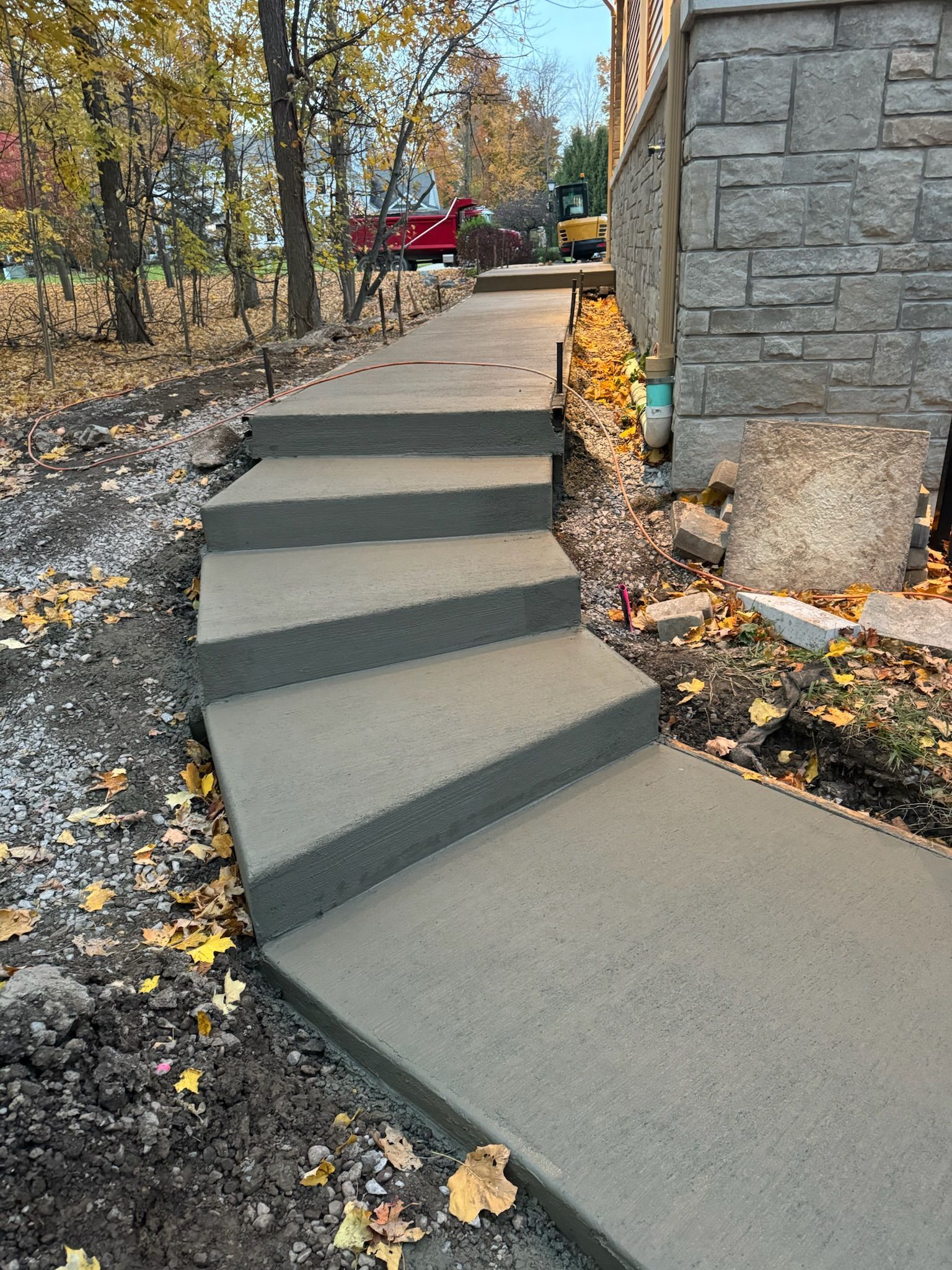A set of concrete stairs leading up to a house.