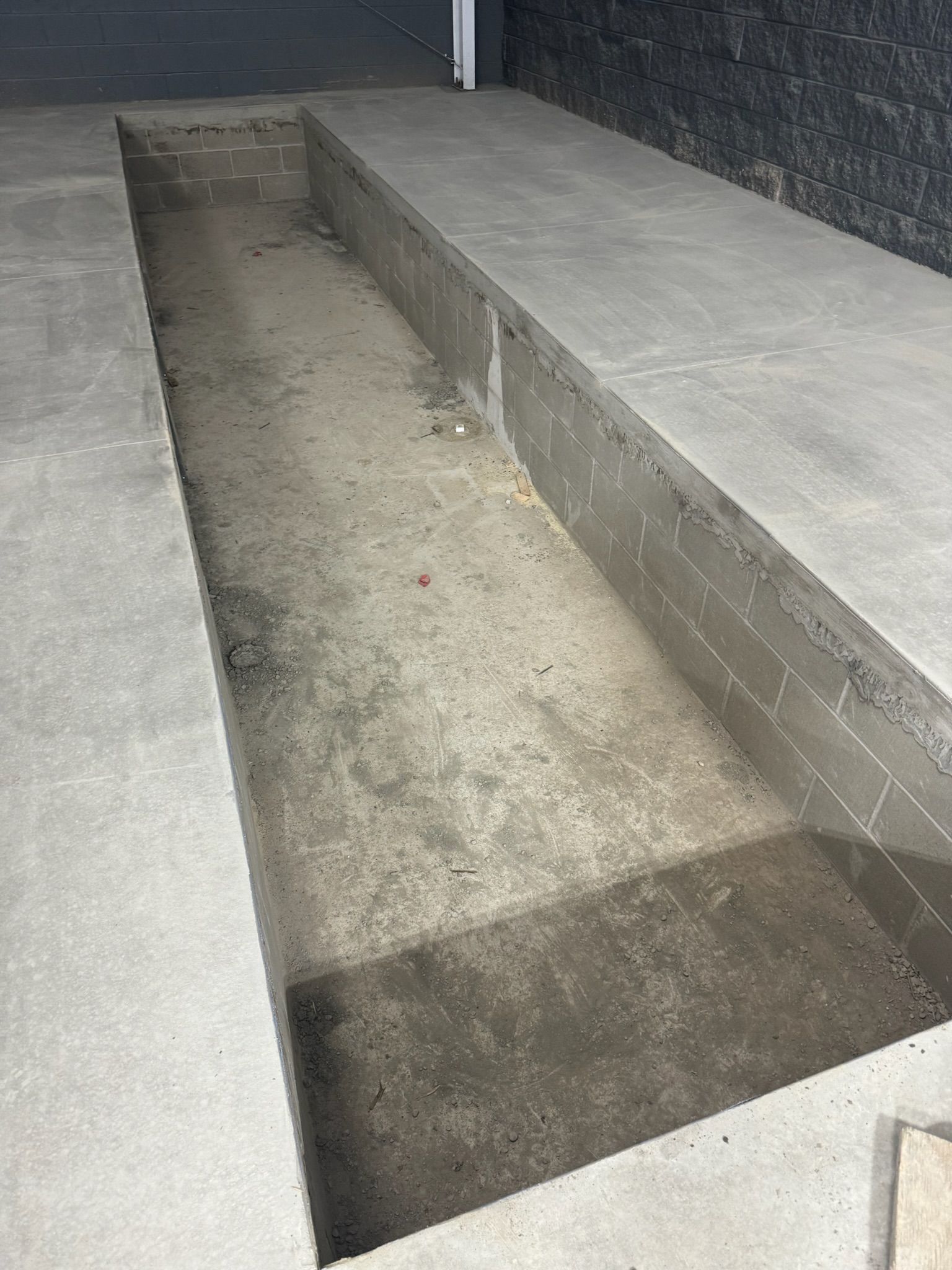 There is a hole in the floor that looks like a pool.