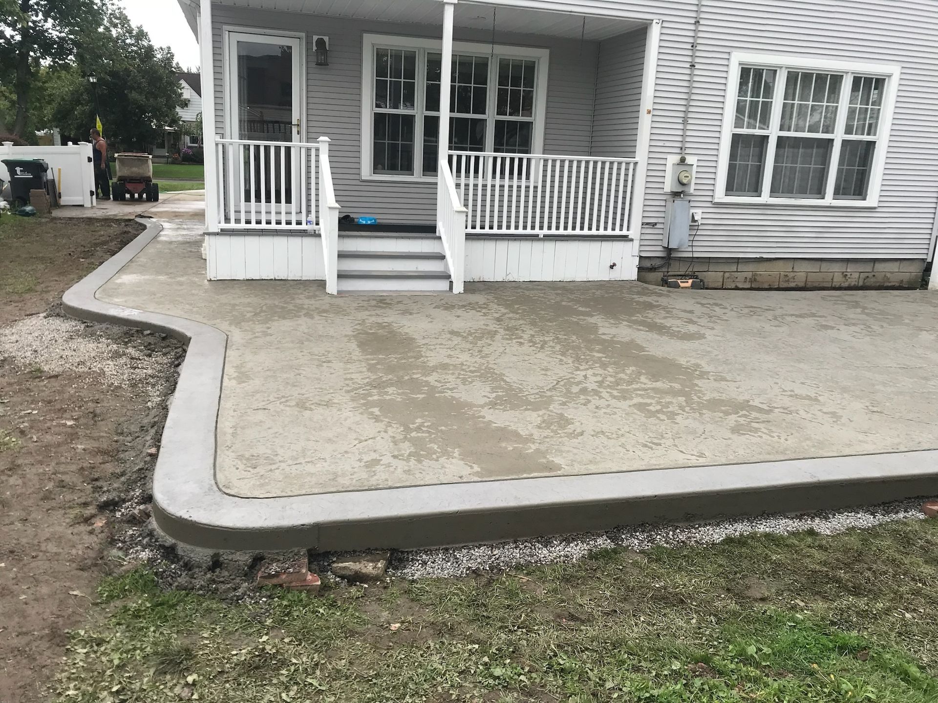 A house with a concrete patio in front of it.