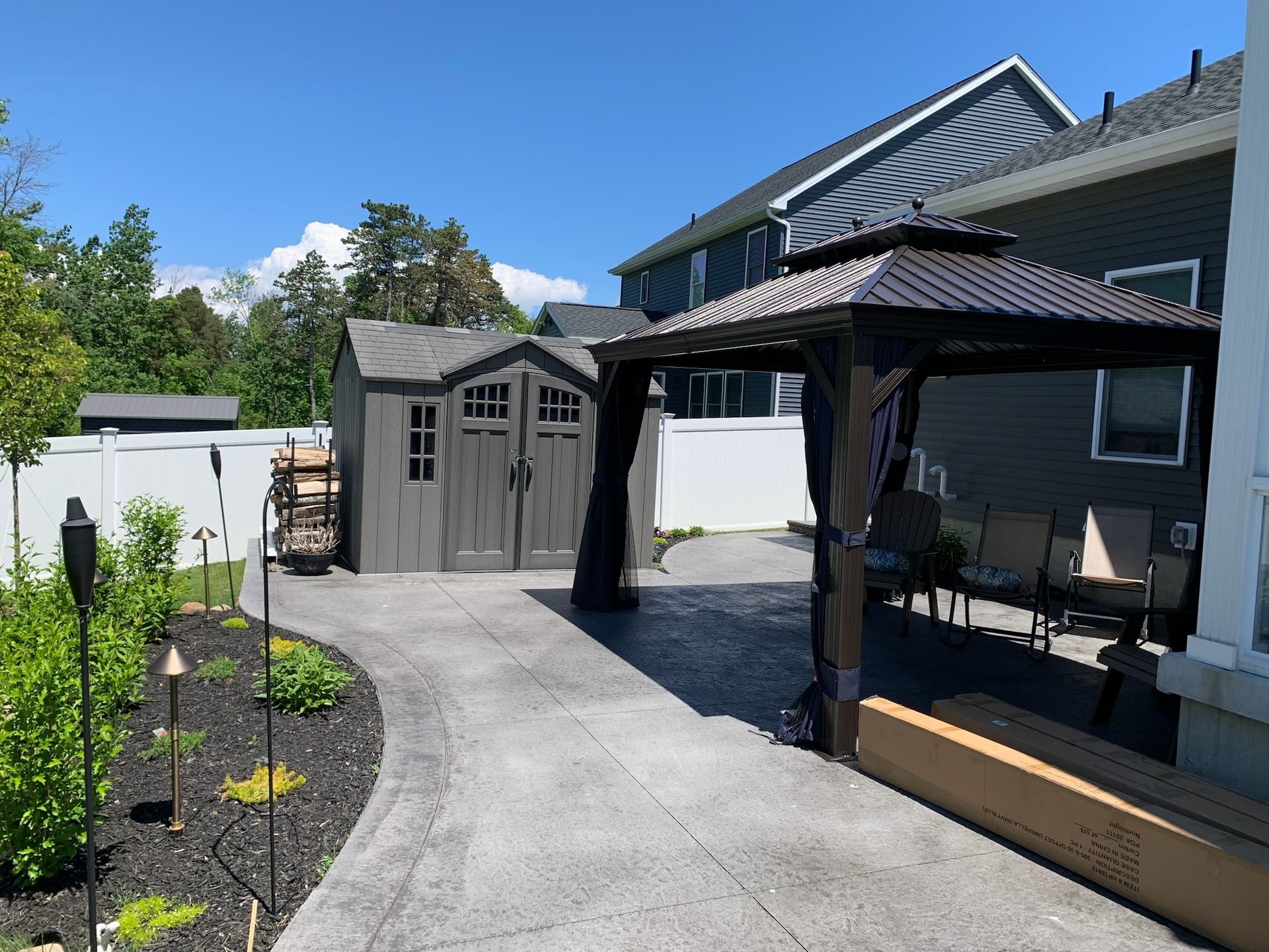 A house with a shed and a gazebo in the backyard
