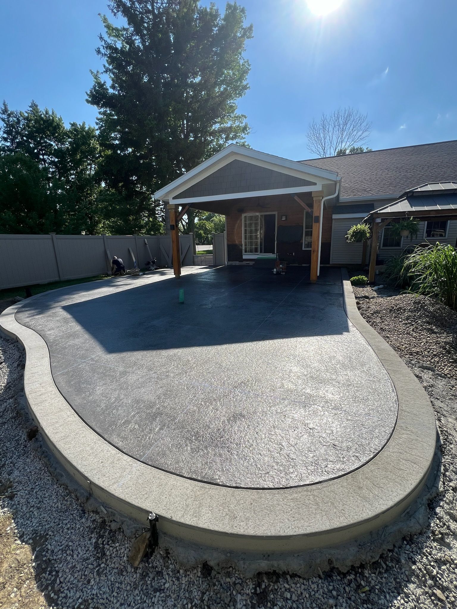 A house with a large concrete patio in front of it.