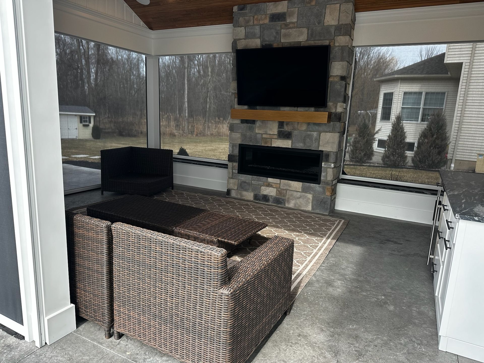 A living room with a fireplace and a flat screen tv
