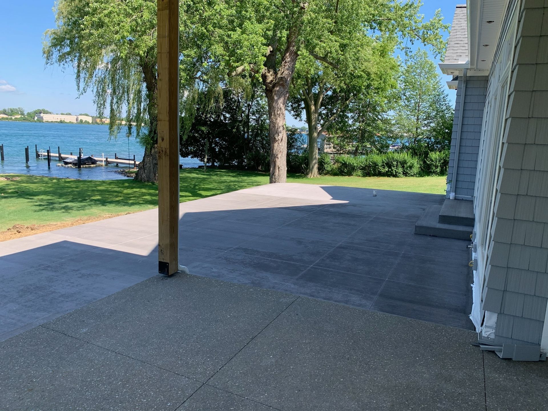 A patio with a view of a lake and trees