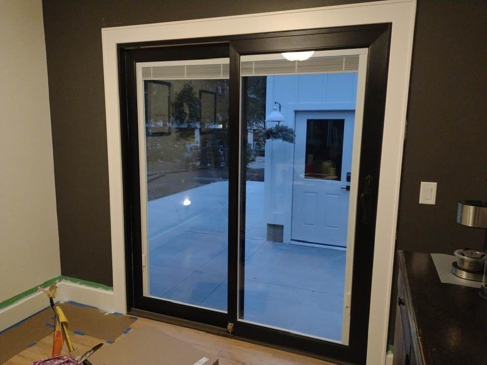 Blue and white Craftsman-style house with a front porch, bushes, and a gray staircase.