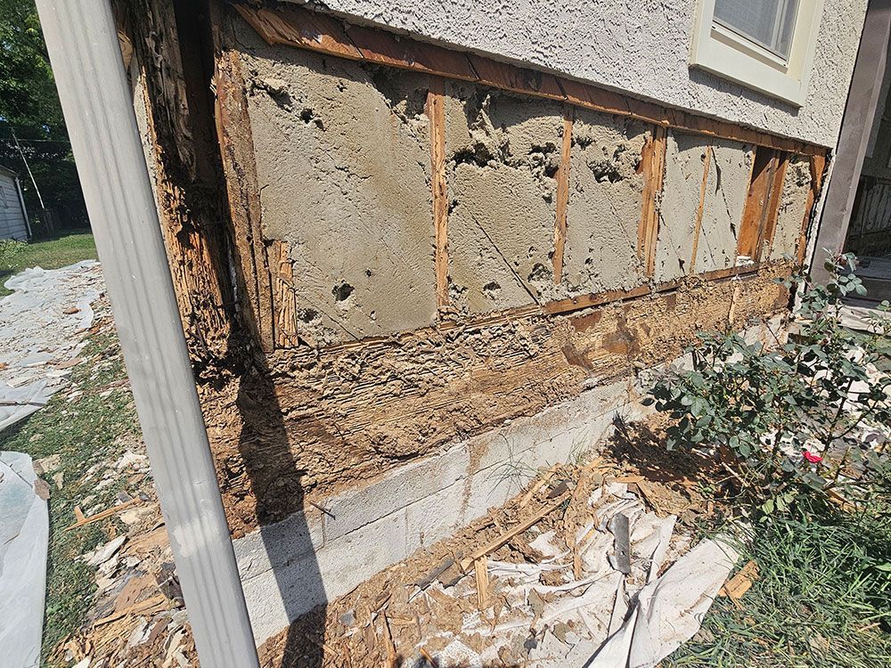 A house with a lot of wood missing from the side of it