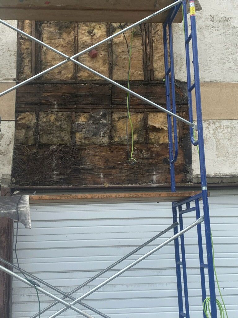 Old wall insulation showing for stucco repair