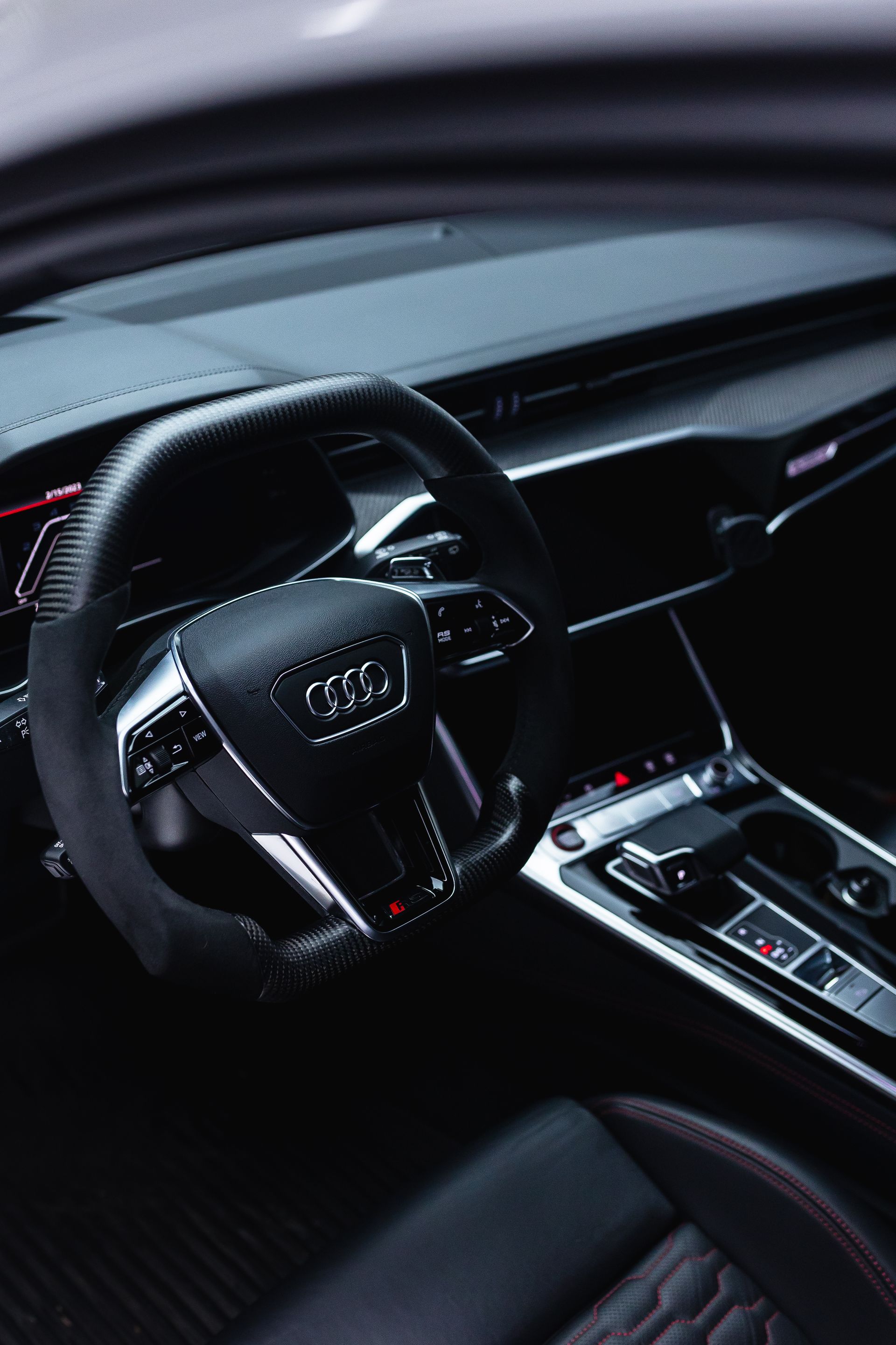 Luxury Audi car interior with black leather seats, steering wheel, and center console