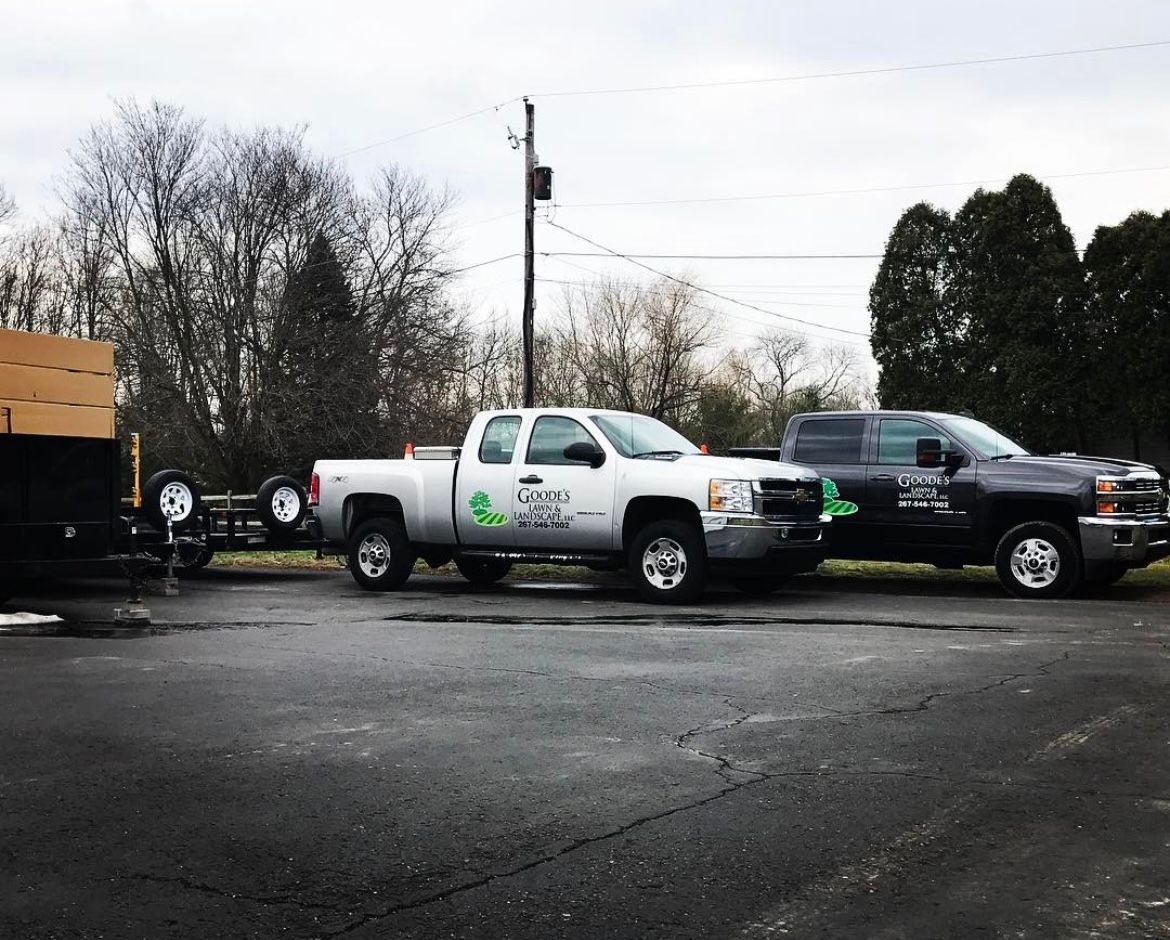 Two trucks are parked next to each other in a parking lot.