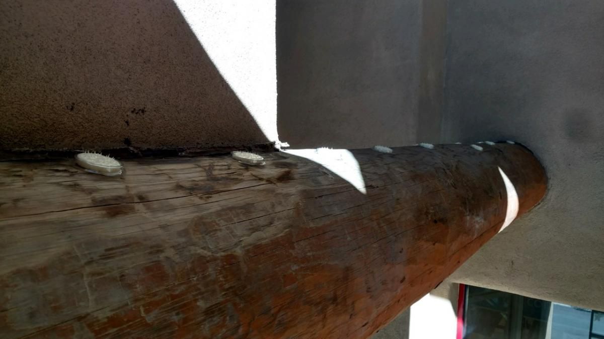 A close up of a piece of wood with a shadow on it.