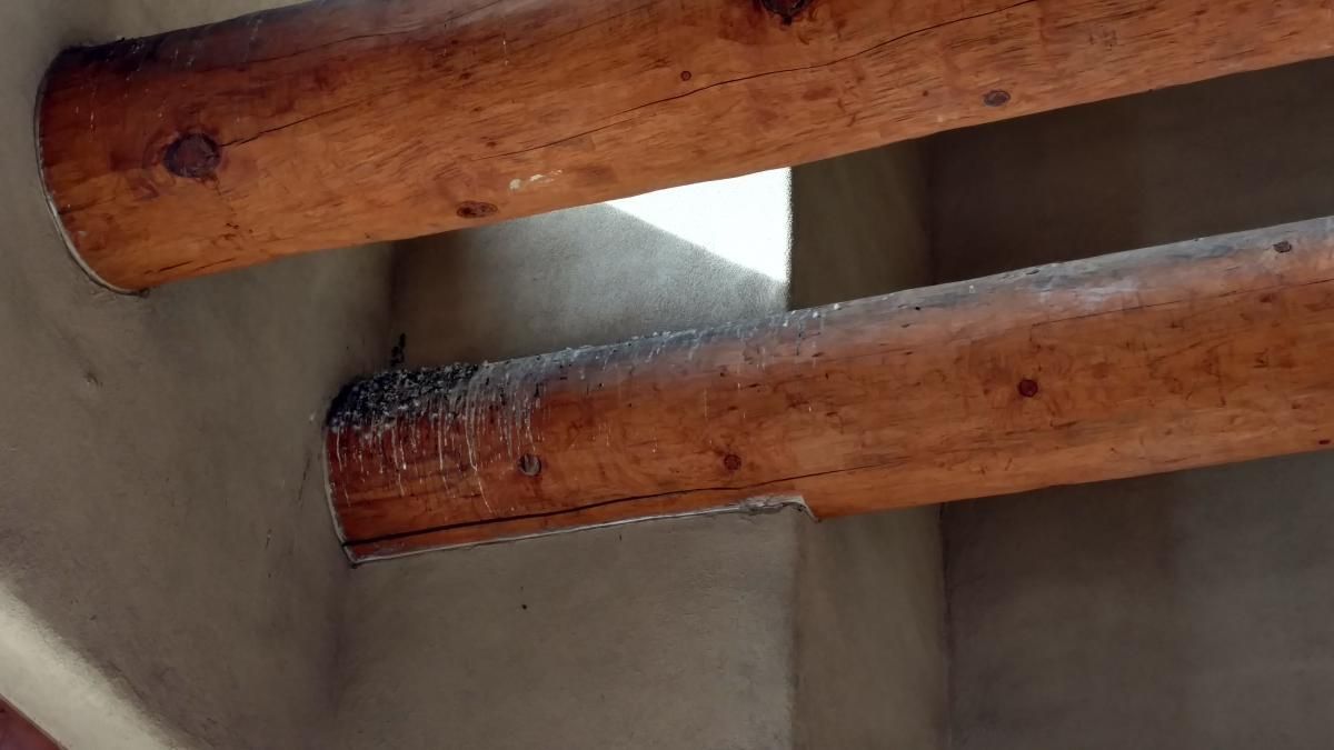 A close up of a wooden railing on a staircase.