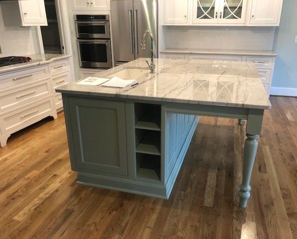 A kitchen with a large island in the middle of it.