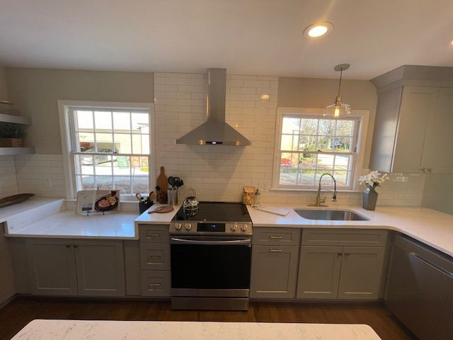 A kitchen with stainless steel appliances and white cabinets