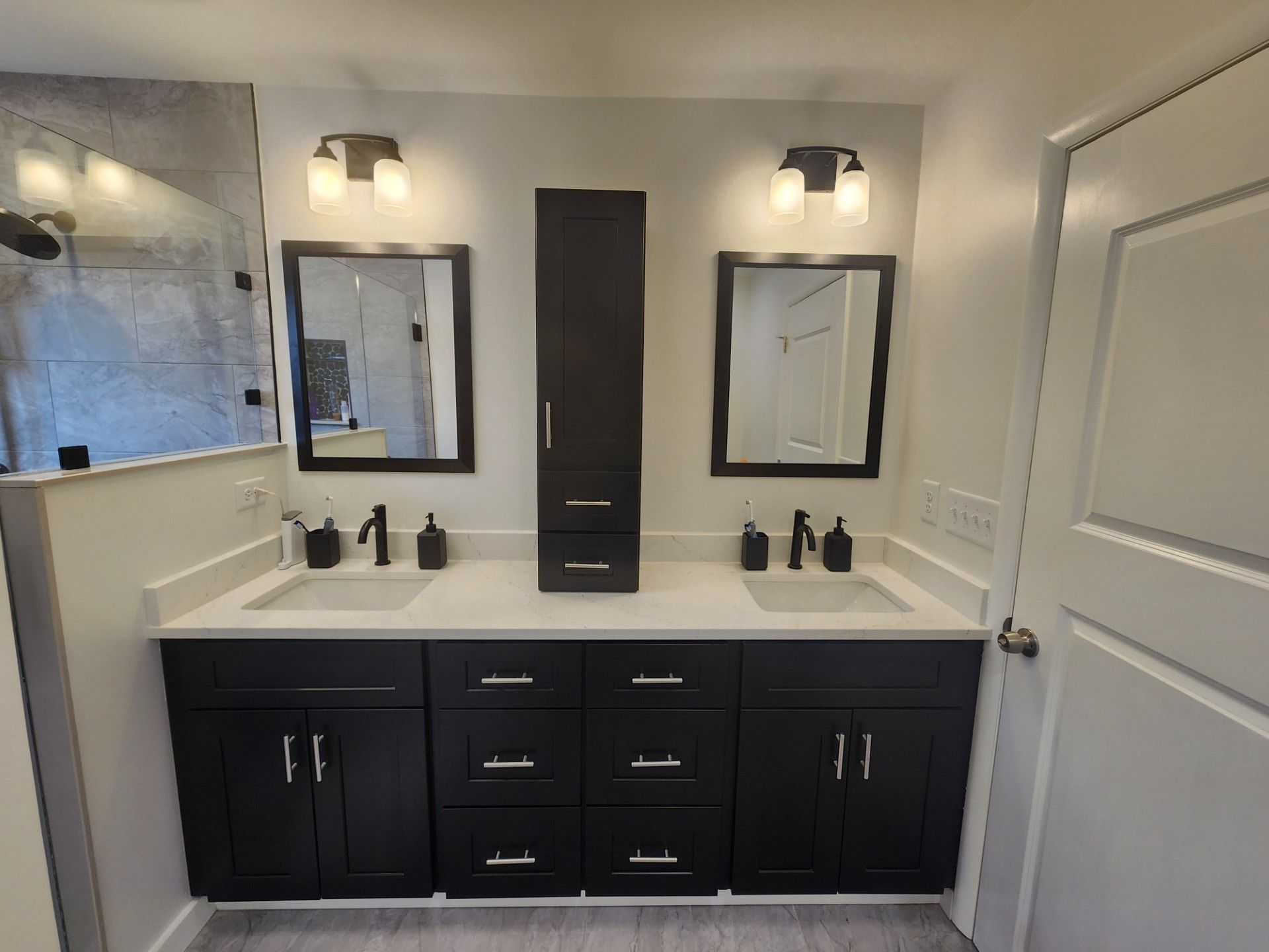 A bathroom with two sinks and two mirrors.