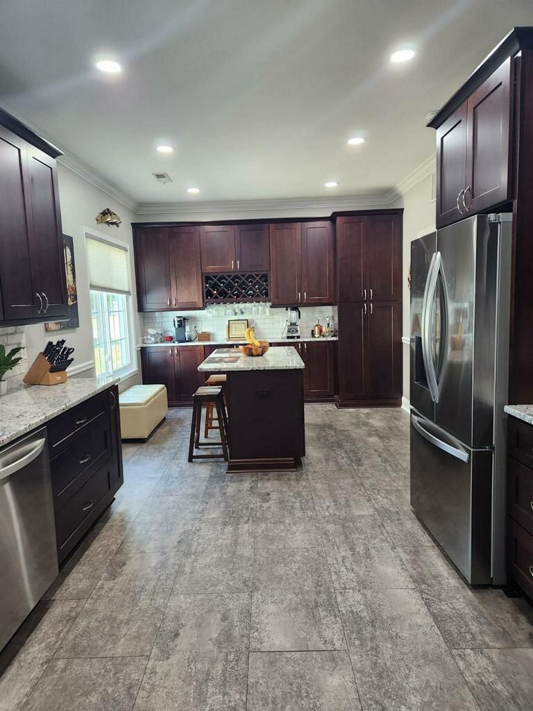 A kitchen with stainless steel appliances and wooden cabinets.