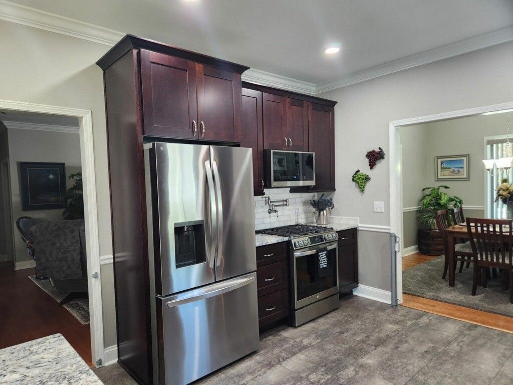 A kitchen with stainless steel appliances and wooden cabinets