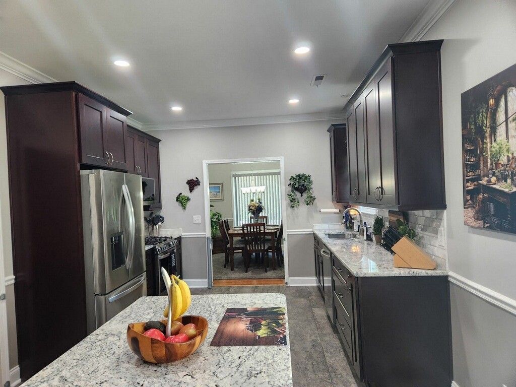 A kitchen with stainless steel appliances and granite counter tops.