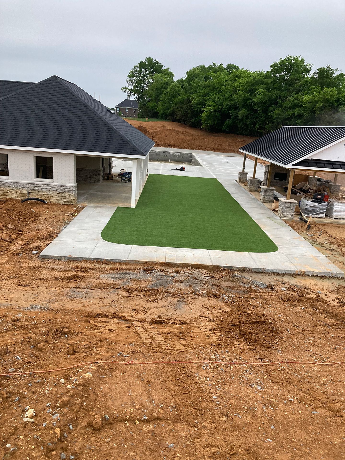 A house is being built in the middle of a dirt field