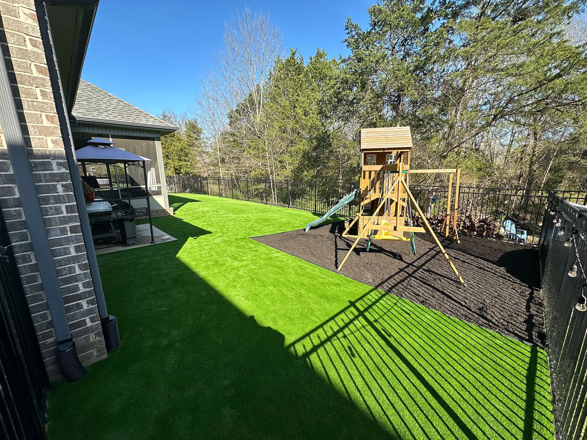 There is a playground in the backyard of a house