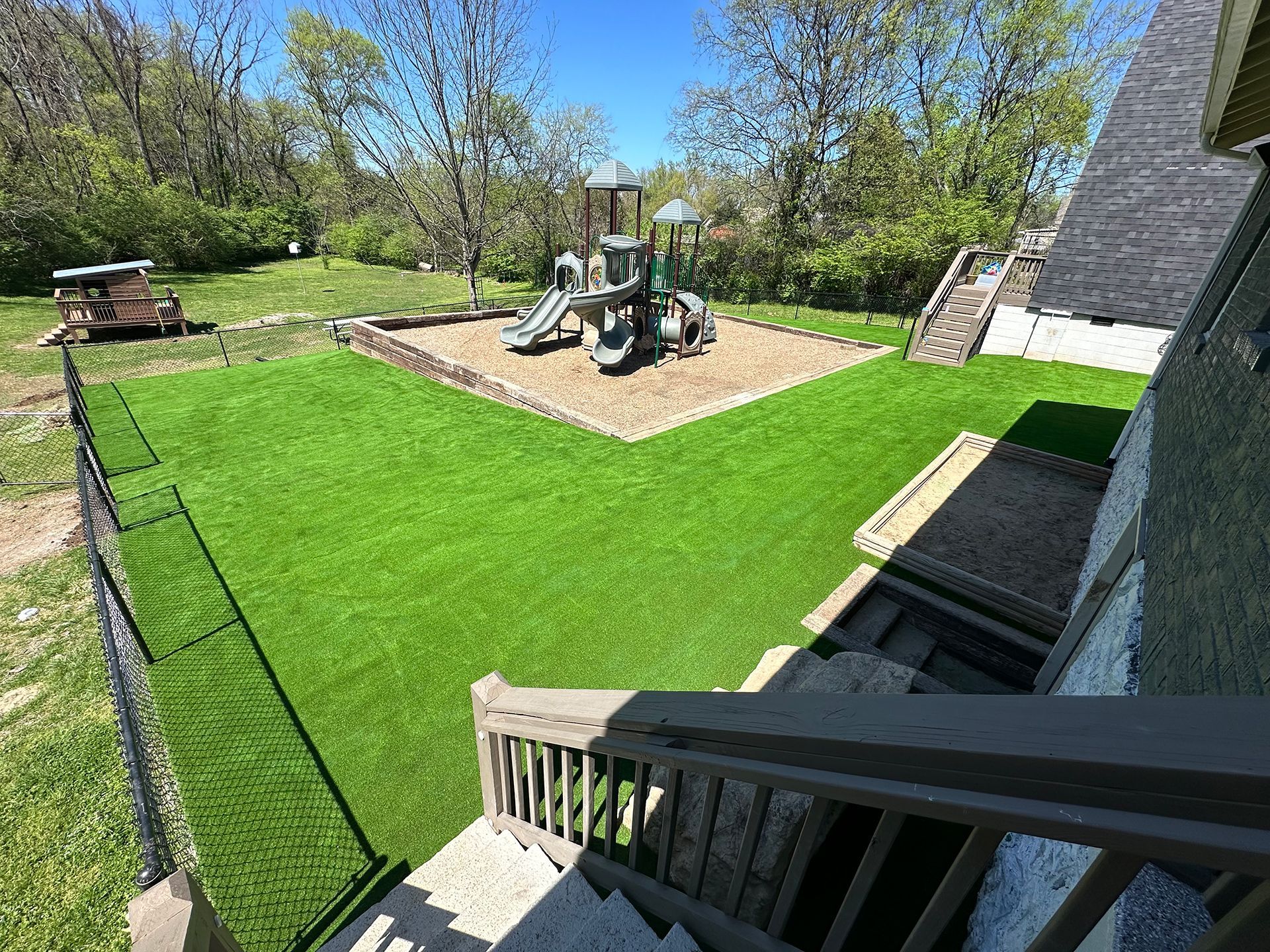 A view of a playground from the stairs of a house