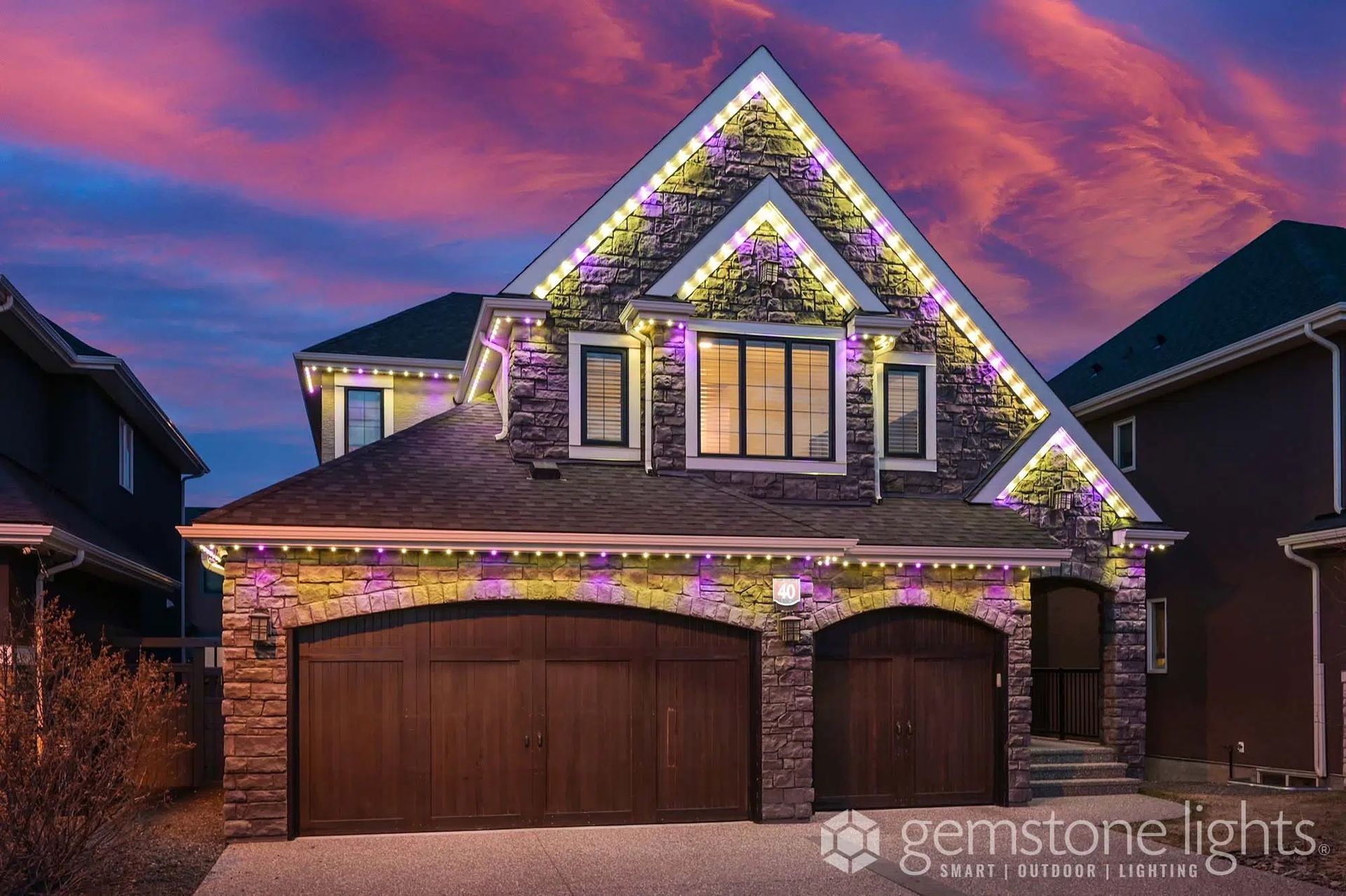 A house with purple and white christmas lights on it