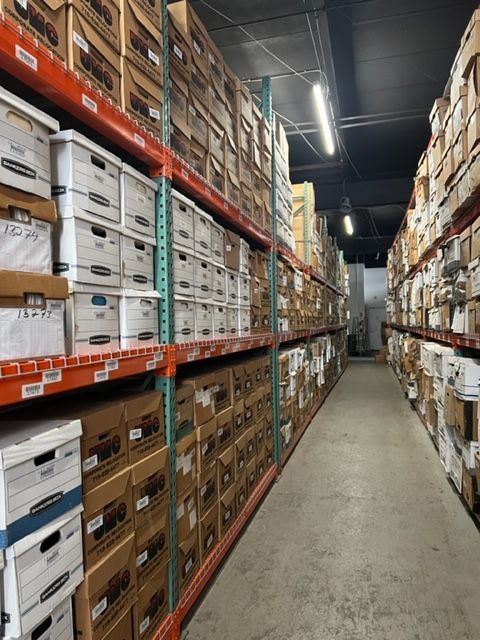 A warehouse filled with lots of boxes and shelves.