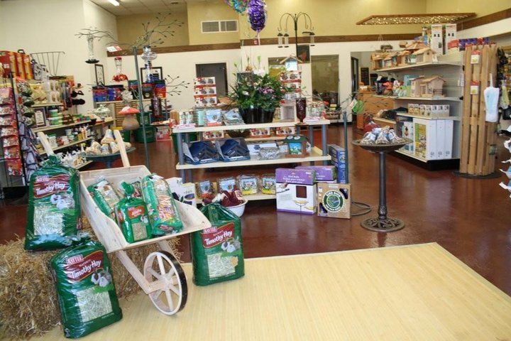 A store with a wheelbarrow filled with bags of food