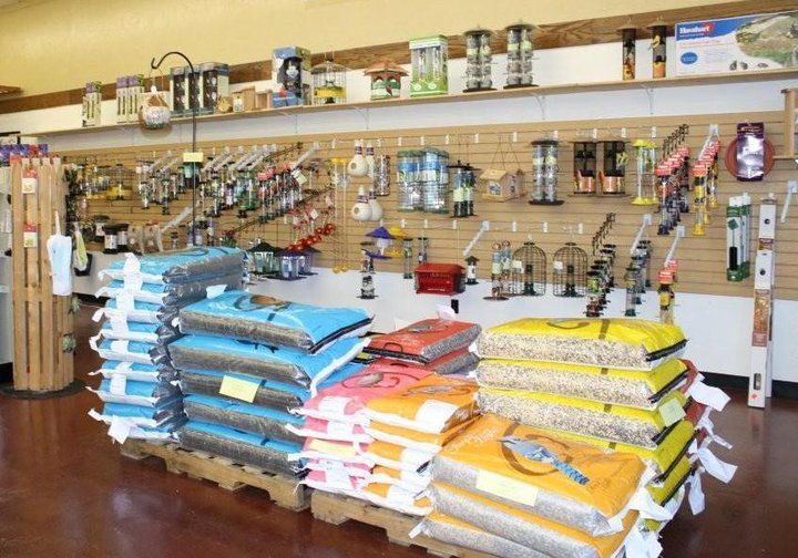 A bunch of bags of food are stacked on top of each other in a store