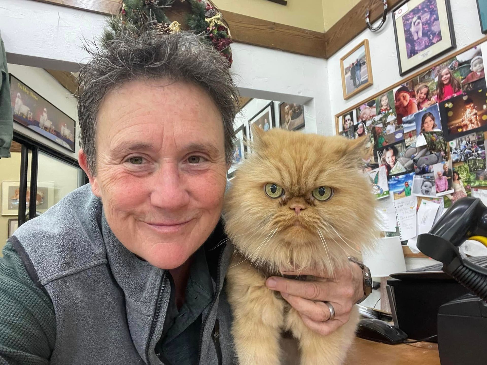 A woman is holding a cat in her arms in a store.