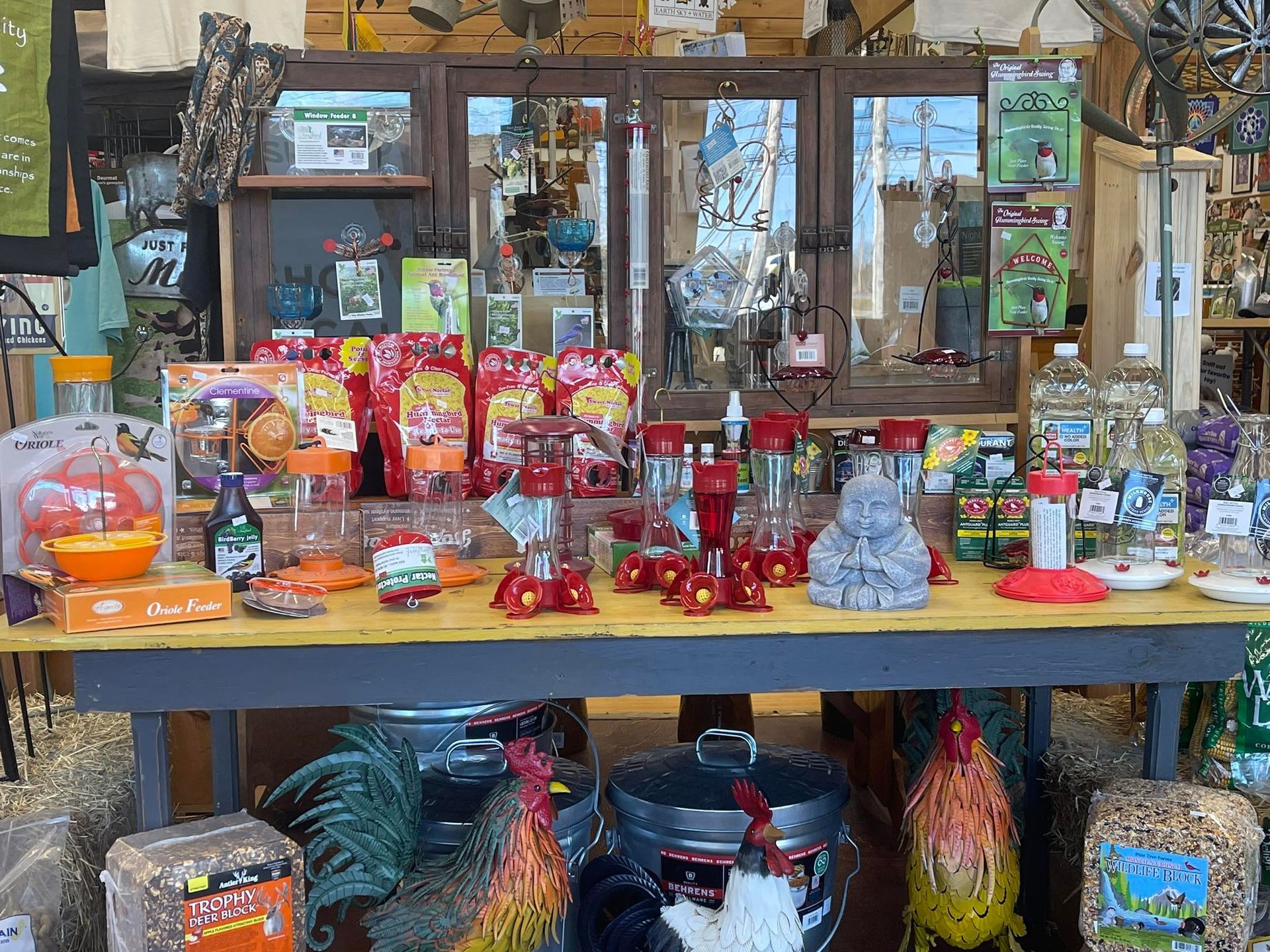 A table filled with lots of bird food and chickens.