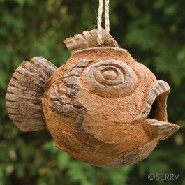 A birdhouse in the shape of a fish is hanging from a rope.