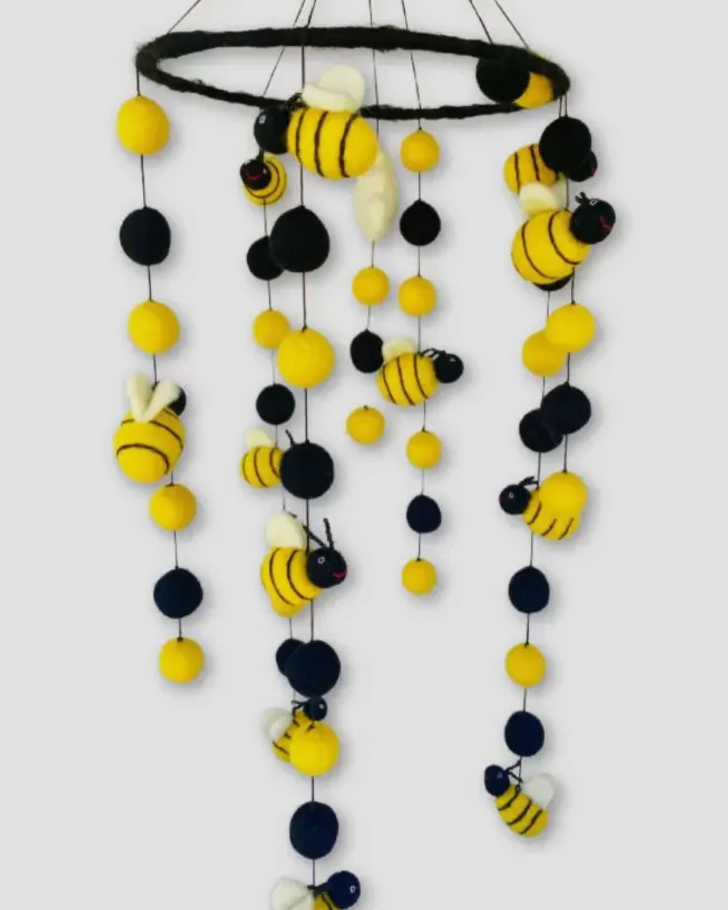 A mobile with yellow and black bees hanging from it
