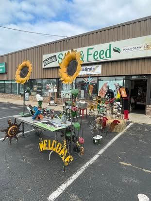 A table with sunflowers on it is in front of a building.