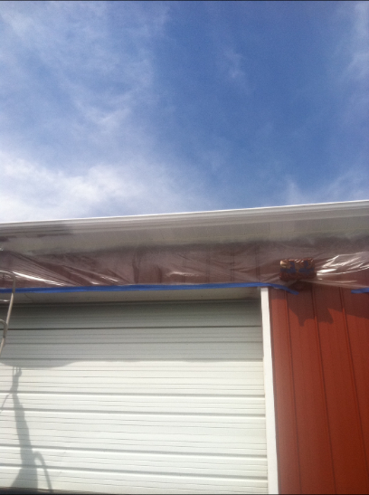 Red and white building exterior with blue sky background.