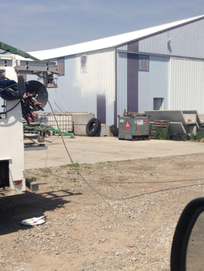 Utility truck with equipment and building in background.