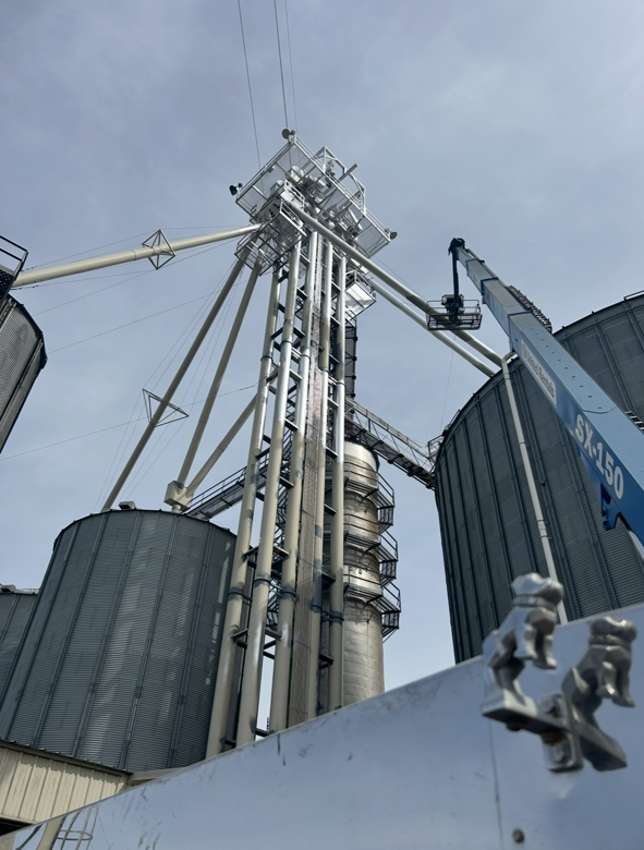 A very tall building with a crane on top of it